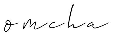 The omcha logo, the word omcha written in thin black script font